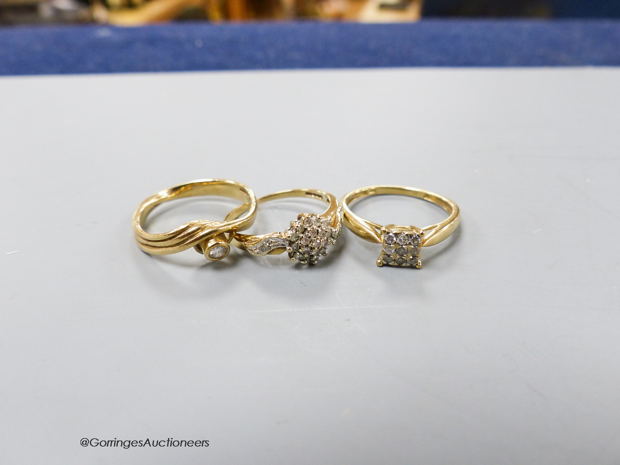 Three assorted modern diamond set dress rings, two stamped 9ct gold and one stamped 375, gross weight 6 grams.